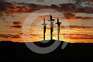 Three crosses over bright sunset with copy space photo